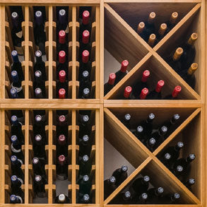 Wooden wine racking complete with different coloured bottles.