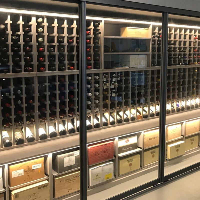 Wooden wine racking stained in grey behind sliding glass doors.