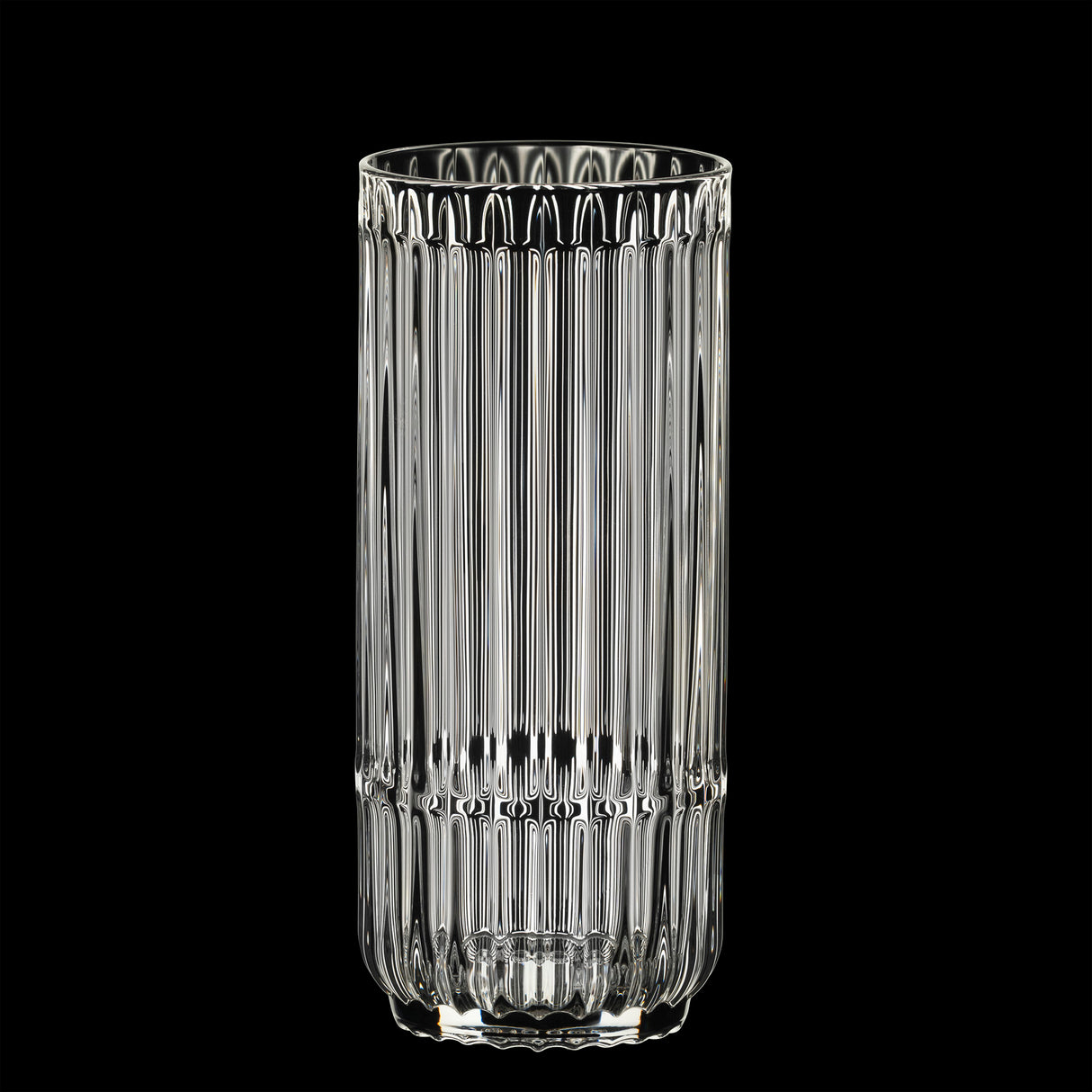 A Riedel Restaurant Bar Rituals Highball Tumbler (321ml) from the 0421/04 set, made from lead-free crystal with vertical ridges, stands tall against a solid black background.
