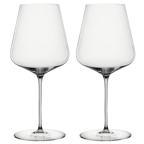 A set of two clear crystal wine glasses with a slender stem, designed for red wine.