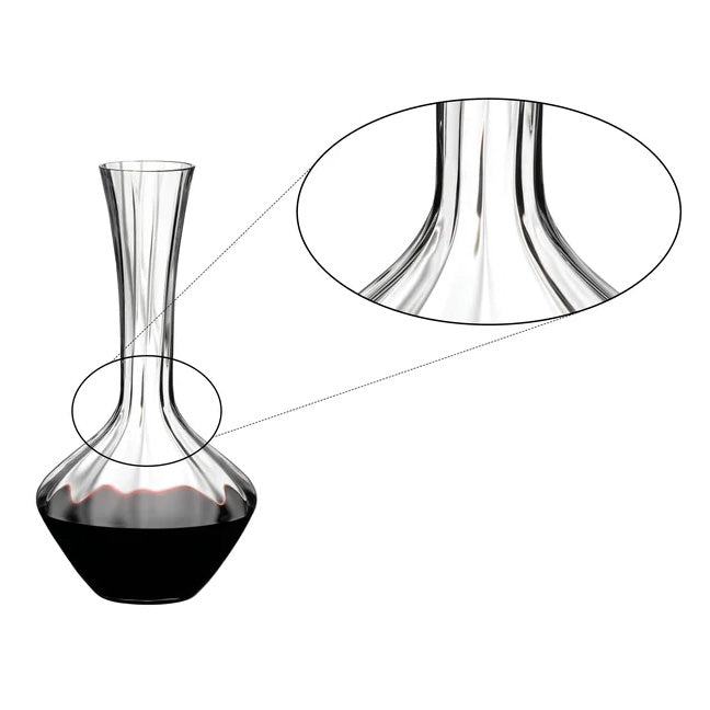 A clear Riedel Manufaktur Exquisit Wine Decanter 1.2L (2025/02), partially filled with red wine, features a close-up inset highlighting the smooth, curved neck as it transitions into the bulbous base. This elegant, handmade decanter by Riedel exemplifies refined craftsmanship and timeless design.