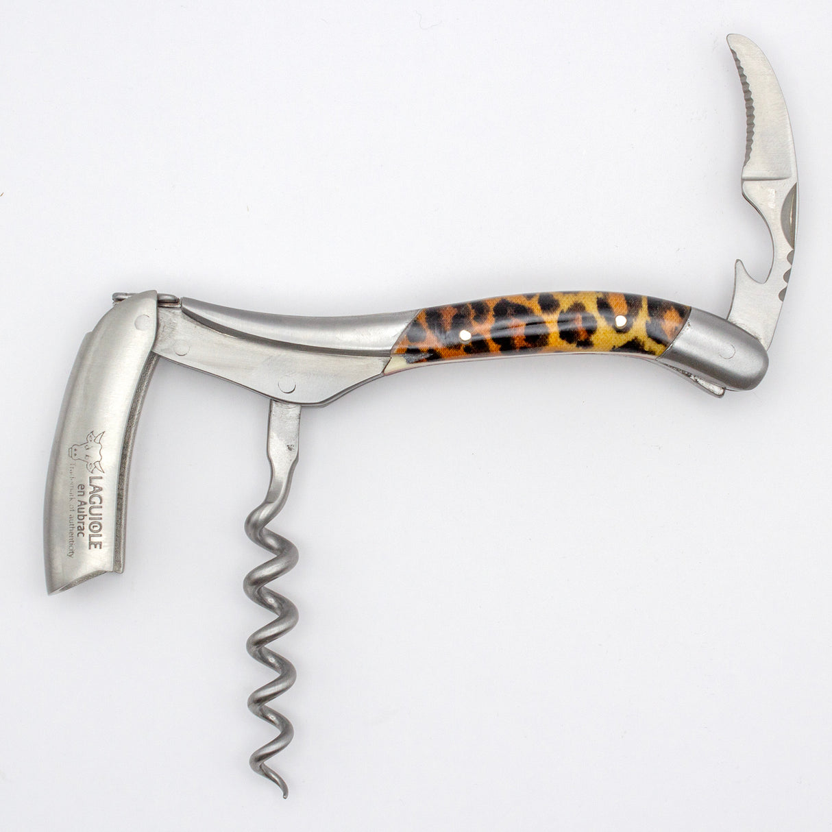 The Laguiole en Aubrac Sommelier Corkscrew features a leopard print handle, folded knife, and bottle opener—a stylish accessory from Laguiole en Aubrac shown on a white background.
