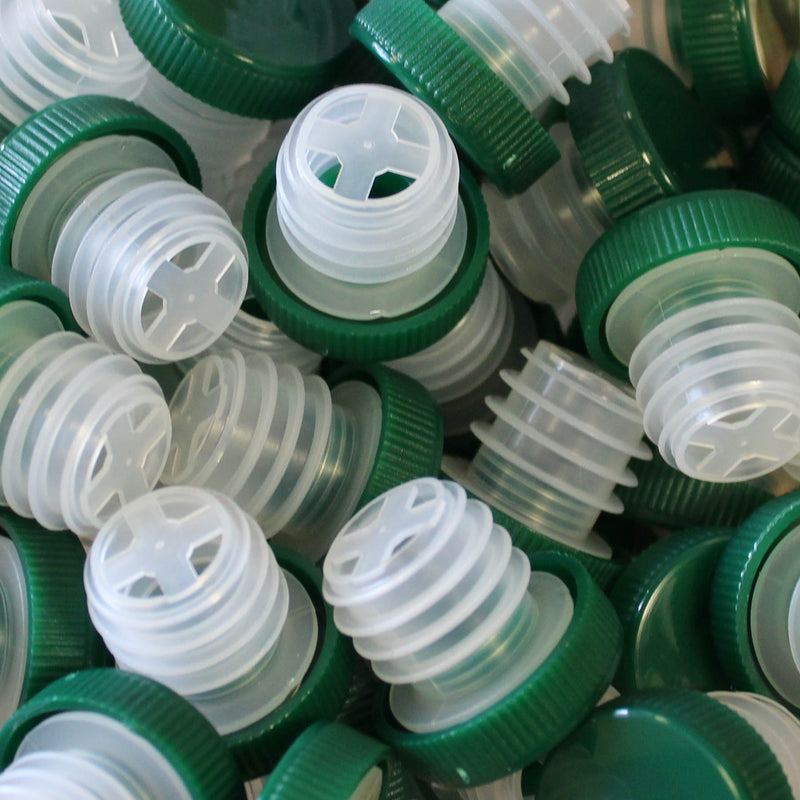 Green and clear bottle tops used for wine tastings