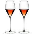 A set of two clear crystal wine glasses filled with rose wine, showcasing a tall stem and a thin bowl.