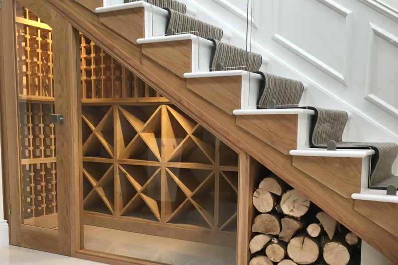 An understairs room with wooden wine racking.
