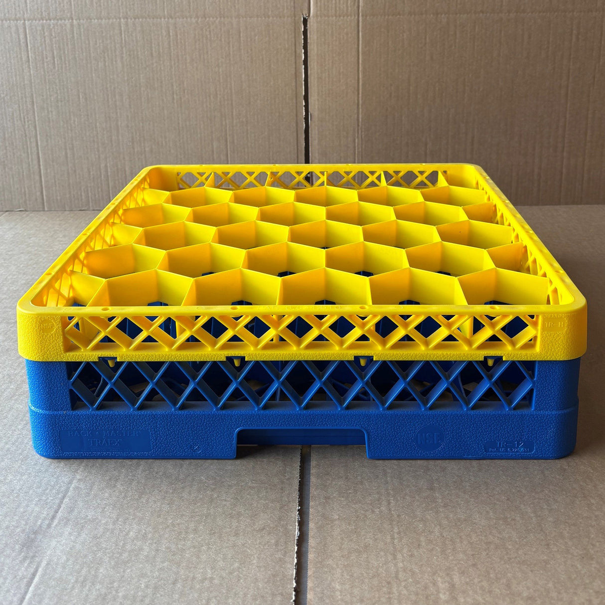 The USED - GREAT CONDITION Traex Rack Master Glass Washer Tray by Wineware (500 x 500 x 120mm, holds 30 glasses in 81mm cells) features a yellow honeycomb-patterned top with a blue base, displayed on cardboard with a similar background.