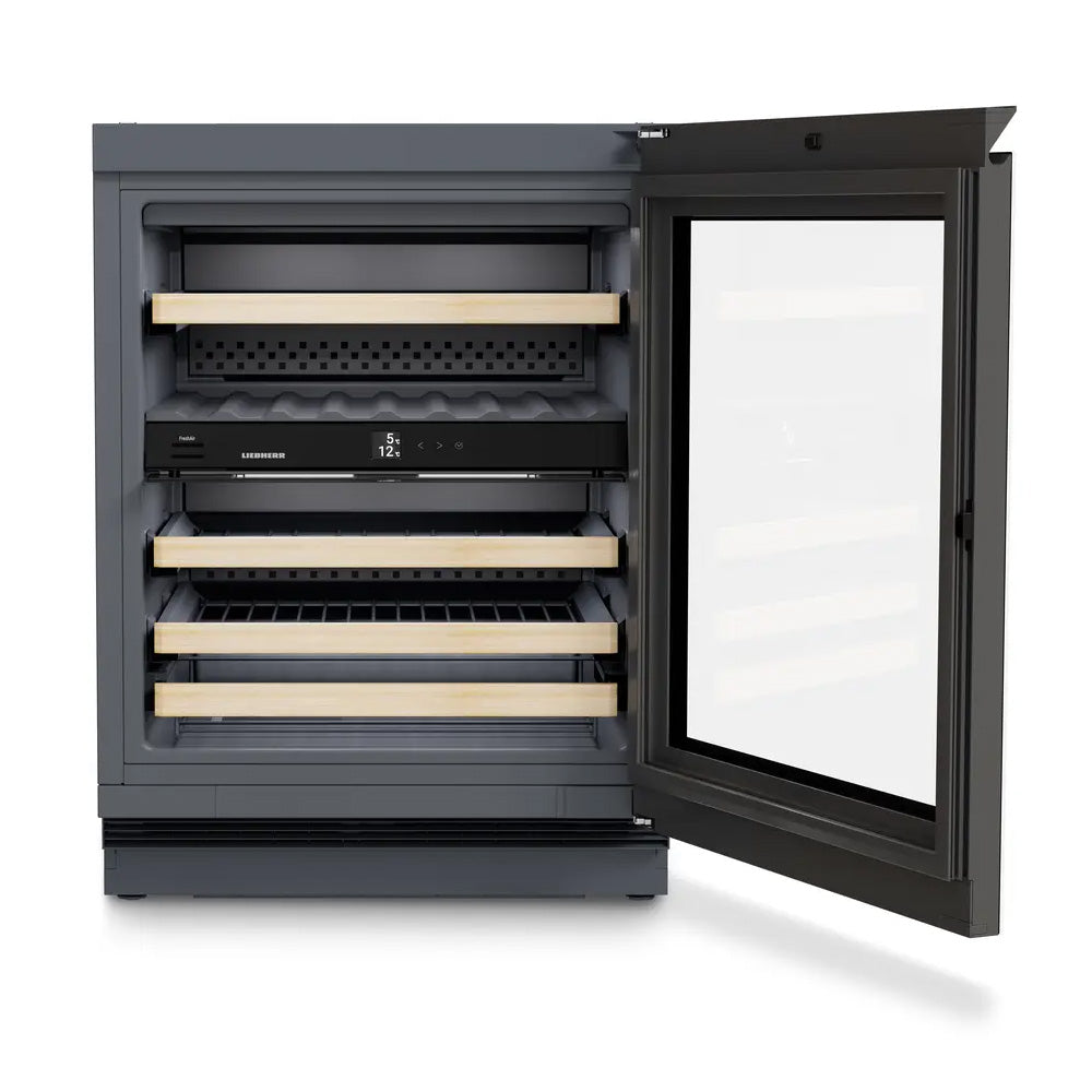 The Liebherr Vinidor 32 Bottle 2-Temperature Undercounter Wine Cabinet (UWgb 3632) features a right-opening glass door, multiple wooden shelves for wine bottles, and an internal digital control panel. The cabinet is shown empty.