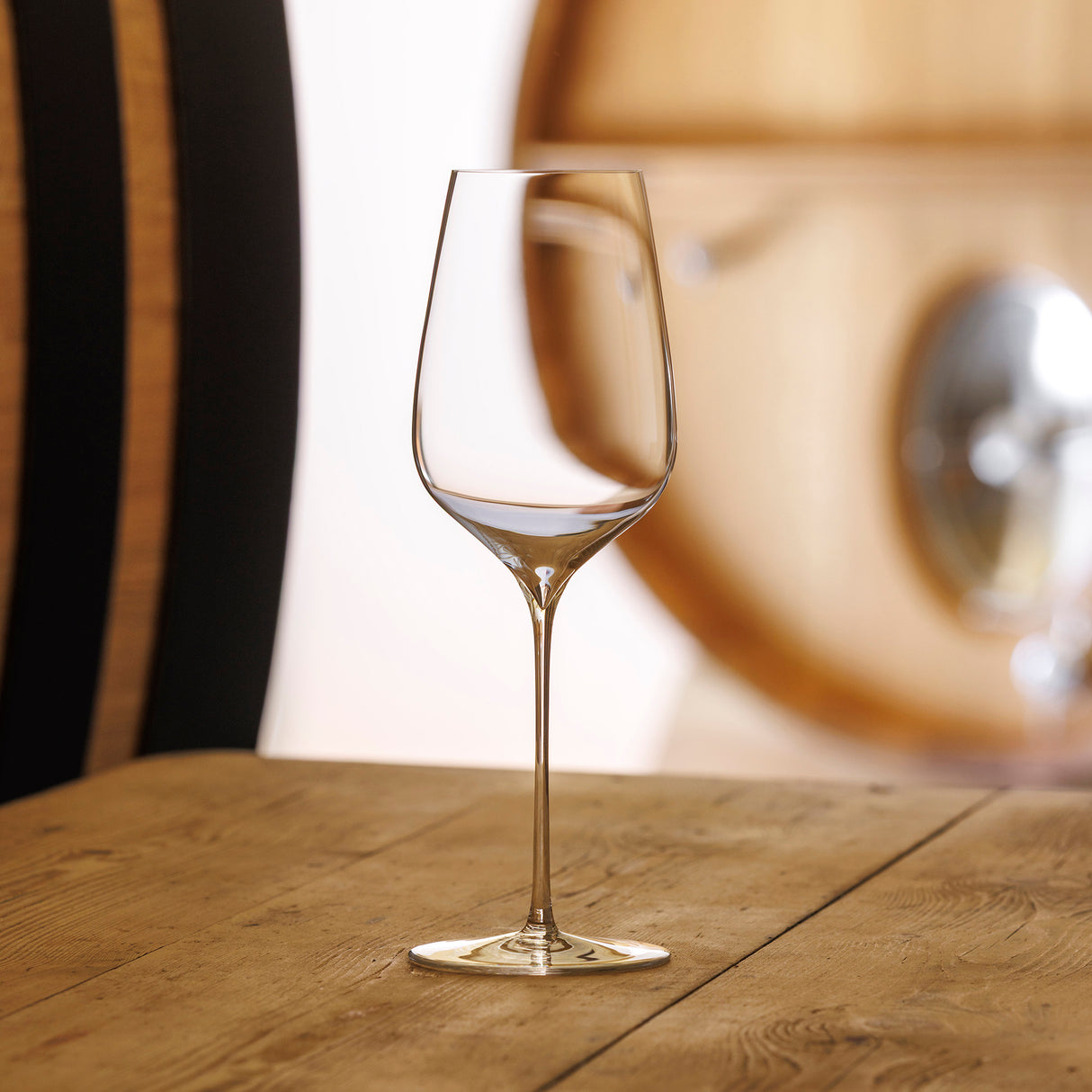 The Sydonios Racine Collection l’Universel Red, White & Champagne Wine Glasses (Set of 2) feature mouth-blown crystal and long stems, ideal for savoring fine wines in a rustic setting reminiscent of a winery.