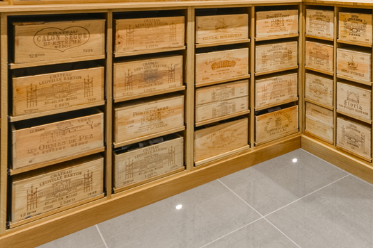 Wooden wine case racking/storage on slide out shelves.