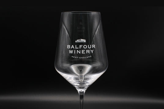 Branded wine glass with 'Balfour Winery' text and logo.