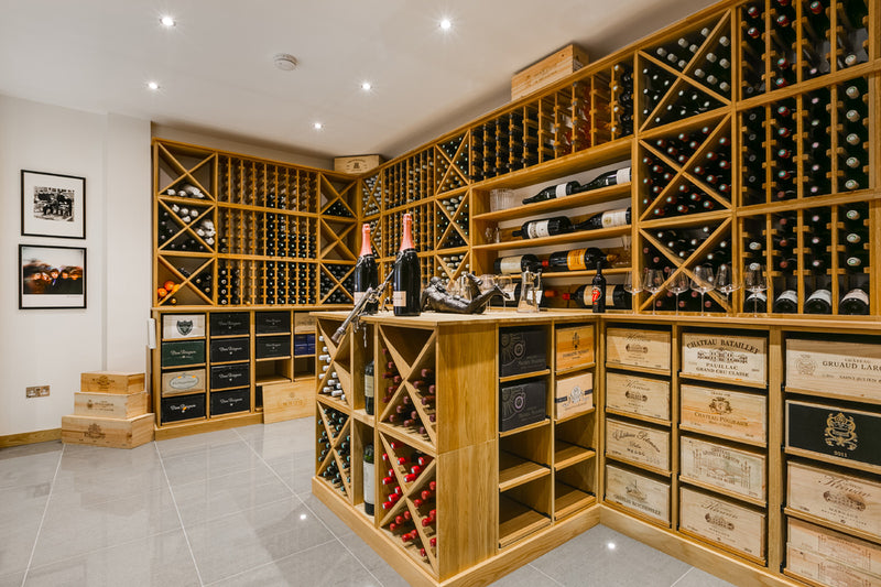 Wine cellar with wooden shelves and wine bottles.