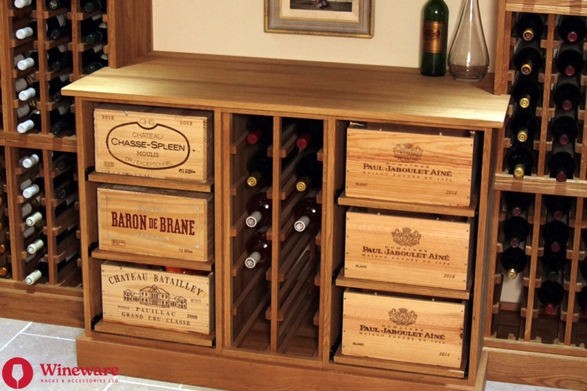Wooden wine cabinet with vintage wine crates and bottles on a wooden floor.