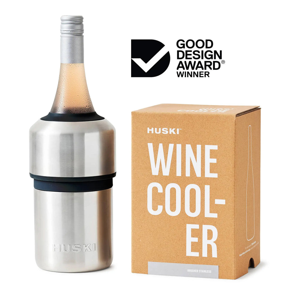 A Huski Wine & Champagne Bottle Cooler - Brushed Stainless Steel stands next to its cardboard packaging, with the Good Design Award Winner logo displayed in the top right corner.