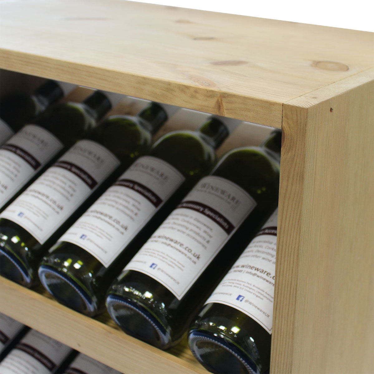 Wine bottles in a wooden rack with visible labels