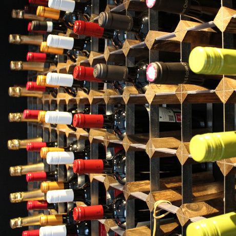 Colourful bottle tops placed within a traditional, wooden and metal wine rack.