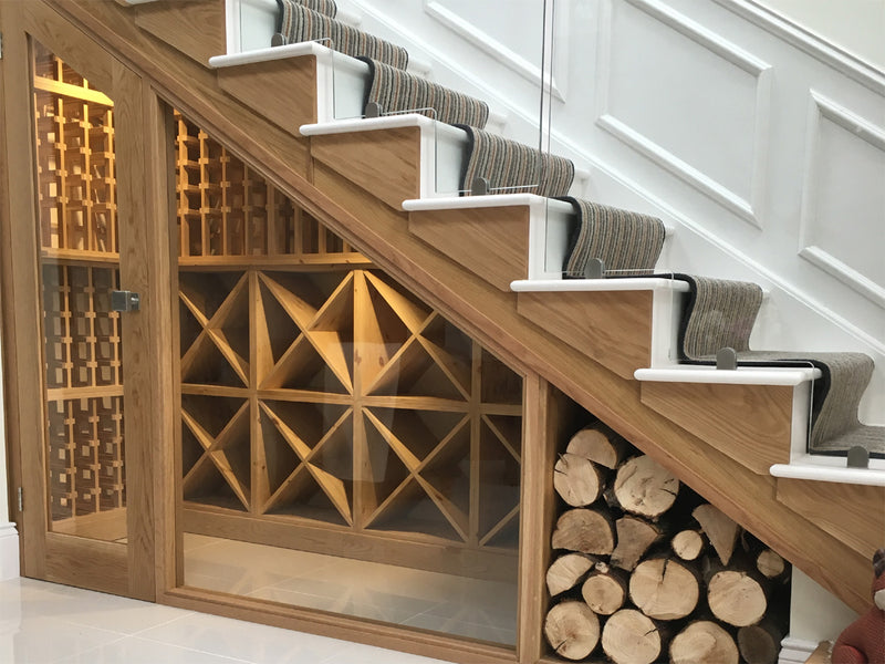 Under-stair wine storage with wooden racks and firewood storage.
