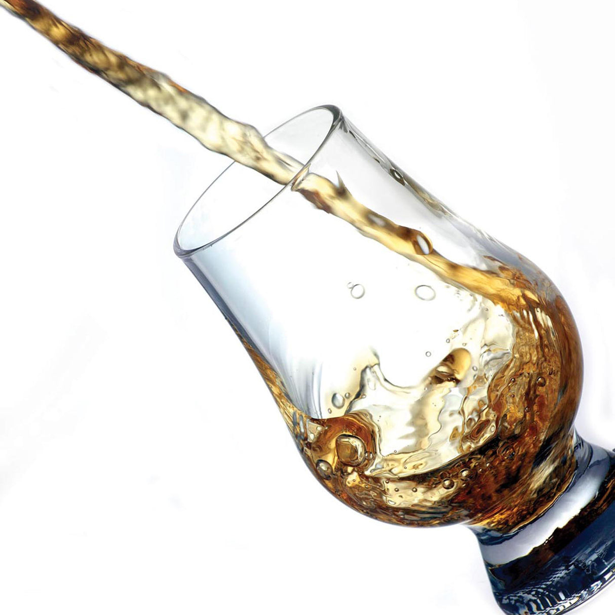 Alcohol being poured into a glass with a white background
