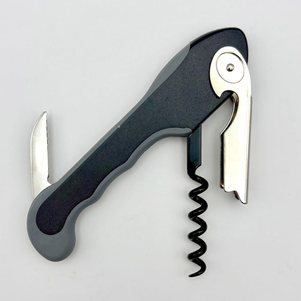 The Soft Touch 001 Single Lever Waiter's Friend Corkscrew by Soft Touch is displayed on a white background, featuring a black and silver design with a serrated foil cutter, bottle opener, and spiral worm.