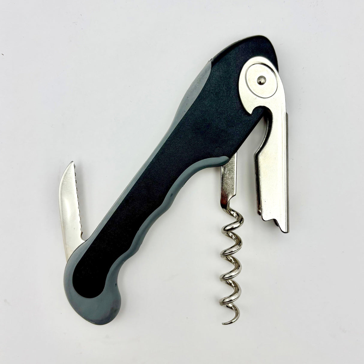 The Soft Touch 001 Single Lever Waiter's Friend Corkscrew by Soft Touch, featuring a black and silver design with a serrated foil cutter blade, lever, and helix screw, is shown against a white background.