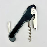 The Soft Touch 001 Single Lever Waiter's Friend Corkscrew by Soft Touch, featuring a black and silver design with a serrated foil cutter blade, lever, and helix screw, is shown against a white background.