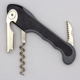 The Soft Touch 001 Single Lever Waiter's Friend Corkscrew by Soft Touch, featuring a black and silver design with an extended bottle opener and serrated foil cutter, is displayed against a plain light background.