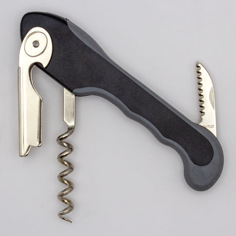 The Soft Touch 001 Single Lever Waiter's Friend Corkscrew by Soft Touch, featuring a black and silver design with an extended bottle opener and serrated foil cutter, is displayed against a plain light background.