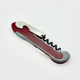 A Soft Touch 001 Single Lever Waiter's Friend Corkscrew by Soft Touch, featuring a red and silver foldable design, is shown closed and lying on a white background.