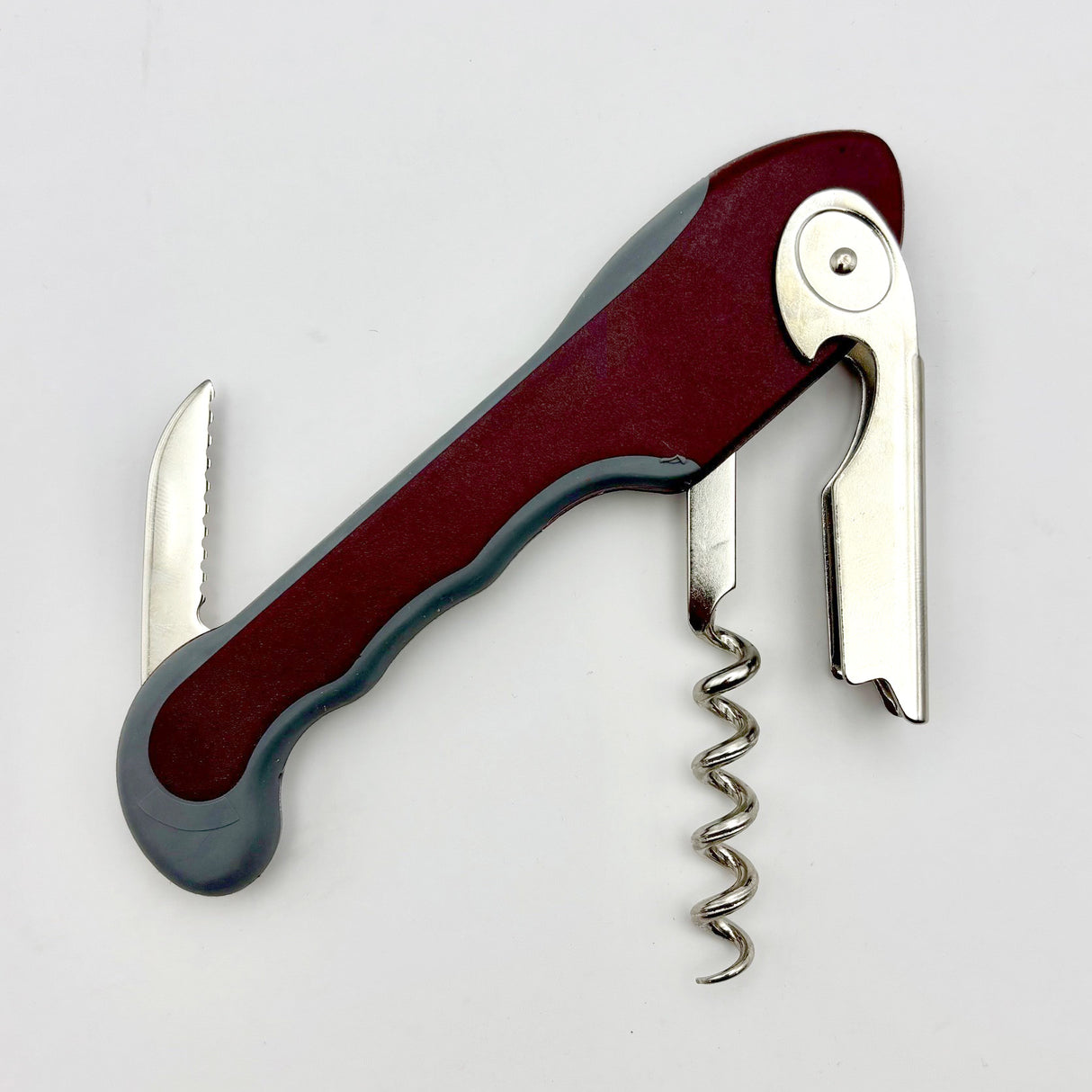 The Soft Touch 001 Single Lever Waiter's Friend Corkscrew by Soft Touch, featuring a maroon handle, is shown partially open to display its corkscrew, bottle opener, and small foil-cutting blade against a plain white background.