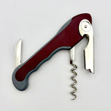 The Soft Touch 001 Single Lever Waiter's Friend Corkscrew by Soft Touch, featuring a maroon handle, is shown partially open to display its corkscrew, bottle opener, and small foil-cutting blade against a plain white background.