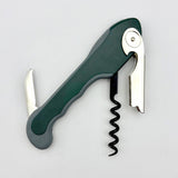 The Soft Touch 001 Single Lever Waiter's Friend Corkscrew by Soft Touch is shown in green and gray on a white background, with its foil cutter, lever, and spiral worm extended. This convenient bottle opener features a single lever design for effortless uncorking.