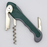 A Soft Touch 001 Single Lever Waiter's Friend Corkscrew by Soft Touch, shown in green and gray, features an open spiral, single lever corkscrew mechanism, a bottle opener lever, and a small serrated knife—all extended.