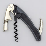 The Soft Touch 002 Double Lever Waiter's Friend Corkscrew by Soft Touch, in black and silver, features a bottle opener, serrated foil cutter, and spiral worm, displayed against a plain light background.
