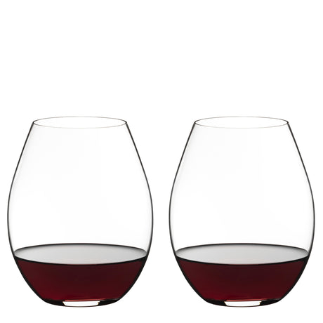 Two Riedel O Range Stemless Old World Syrah Glasses (Set of 2) by Riedel, each partially filled with red wine, are placed side by side against a plain white background. With their modern silhouette, these glasses are both elegant and fully dishwasher safe for convenient cleanup.