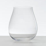 Two Riedel O Range Stemless New World Pinot Noir glasses (Set of 2 - 0414/67) sit elegantly on a white surface against a plain white background. With their wide, rounded base and gently narrowing silhouette, these clear glass pieces reflect the refined design Riedel is known for. Dishwasher friendly and stylishly understated, they complement any setting with ease.