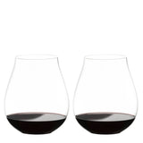 Two Riedel O Range Stemless New World Pinot Noir glasses by Riedel, each filled with red wine to about one quarter full, are placed side by side on a white background. These elegant crystal glasses come as a set of two (model 0414/67) and are both visually striking and dishwasher safe for effortless cleanup.