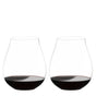 Two Riedel O Range Stemless New World Pinot Noir glasses by Riedel, each filled with red wine to about one quarter full, are placed side by side on a white background. These elegant crystal glasses come as a set of two (model 0414/67) and are both visually striking and dishwasher safe for effortless cleanup.