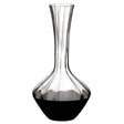 A Riedel Manufaktur Exquisit Wine Decanter 1.2L by Riedel, featuring a wide base that narrows at the neck, is partially filled with red wine.