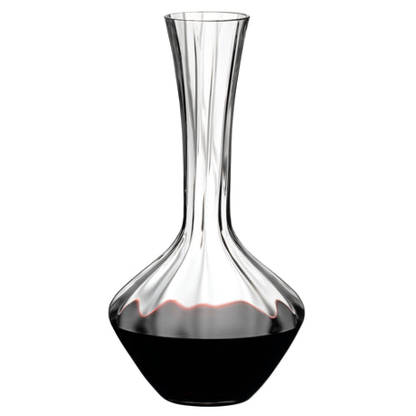A Riedel Manufaktur Exquisit Wine Decanter 1.2L by Riedel, featuring a wide base that narrows at the neck, is partially filled with red wine.