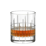 A Stölzle Manhattan Bar Whisky Tumbler 320ml crystal glass with a vertical and horizontal etched grid pattern, containing a measure of amber liquid.