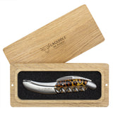 A Laguiole en Aubrac Sommelier Corkscrew with a leopard print handle sits in a foam-lined wooden box. The box lid, engraved with the Laguiole en Aubrac logo, rests diagonally on top.