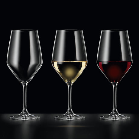 Three crystal wine glasses are lined up side by side: the left glass is empty, the middle contains white wine, and the right contains red wine. The sleek design of each Spiegelau Festino Universal Red & White Wine Glass from Spiegelau stands out against the black background, highlighting their elegance and durability. These glasses come in a set of 6 and are dishwasher safe for easy cleaning.