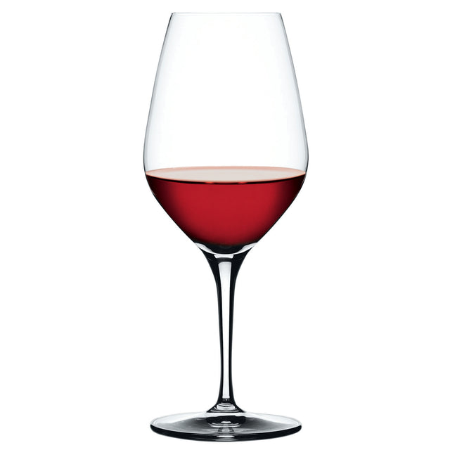 A Spiegelau Restaurant Authentis Red Wine Glass (480ml) from the set of 12, partially filled with red wine, stands elegantly on a white background.
