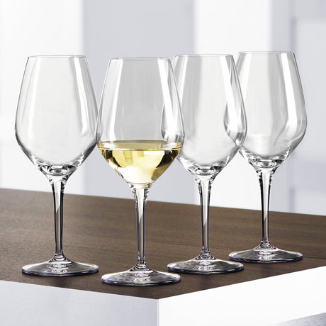 Four Spiegelau Restaurant Authentis Universal/White Wine Glasses (420ml, set of 12) are arranged on a wooden surface; three are empty and one holds white wine, with a bright minimalistic background showcasing Spiegelau elegance.