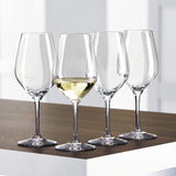 Twelve Spiegelau Restaurant Authentis Small White Wine Glasses by Spiegelau, each with a 360ml capacity, are arranged on a wooden and white surface; three glasses remain empty while one is filled with white wine, showcasing the professional crystal design's elegance and craftsmanship.