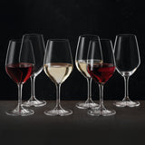 Six Spiegelau Expert Wine Tasting Glasses (260ml each) by Spiegelau are arranged on a table against a dark background—two are filled with red wine, two with white wine, and two remain empty—all expertly crafted from exquisite crystalline glass.