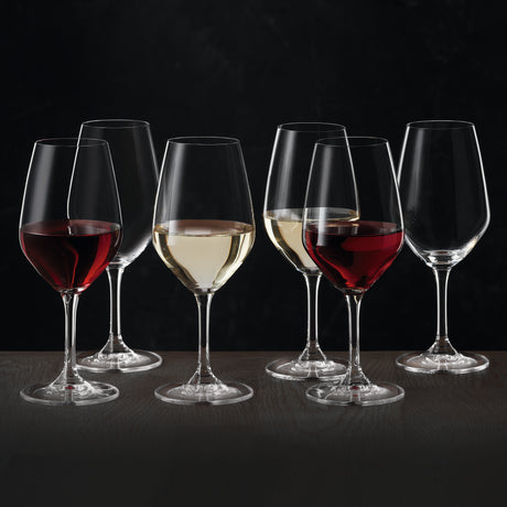 Six Spiegelau Expert Wine Tasting Glasses (260ml each) by Spiegelau are arranged on a table against a dark background—two are filled with red wine, two with white wine, and two remain empty—all expertly crafted from exquisite crystalline glass.