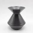 The Zalto Crystal Wine Tasting Spittoon - Dark Grey / Small by Zalto features a sleek, glossy finish with a wide flared top and bottom connected by a narrow center, shown against a plain white background.