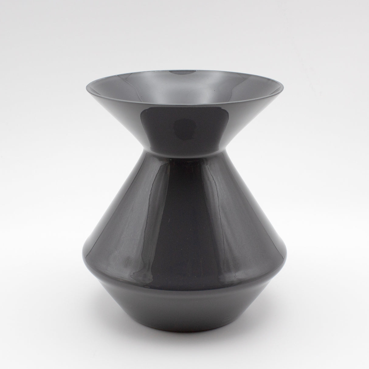 The Zalto Crystal Wine Tasting Spittoon - Dark Grey / Small by Zalto features a sleek, glossy finish with a wide flared top and bottom connected by a narrow center, shown against a plain white background.