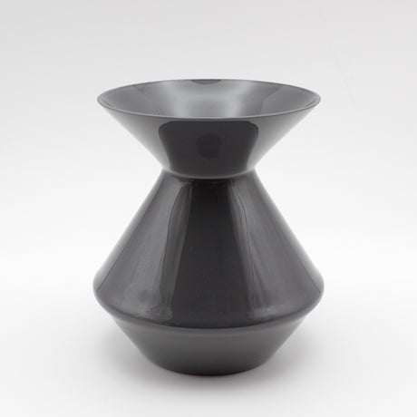 The Zalto Crystal Wine Tasting Spittoon - Dark Grey / Small by Zalto features a sleek, glossy finish with a wide flared top and bottom connected by a narrow center, shown against a plain white background.