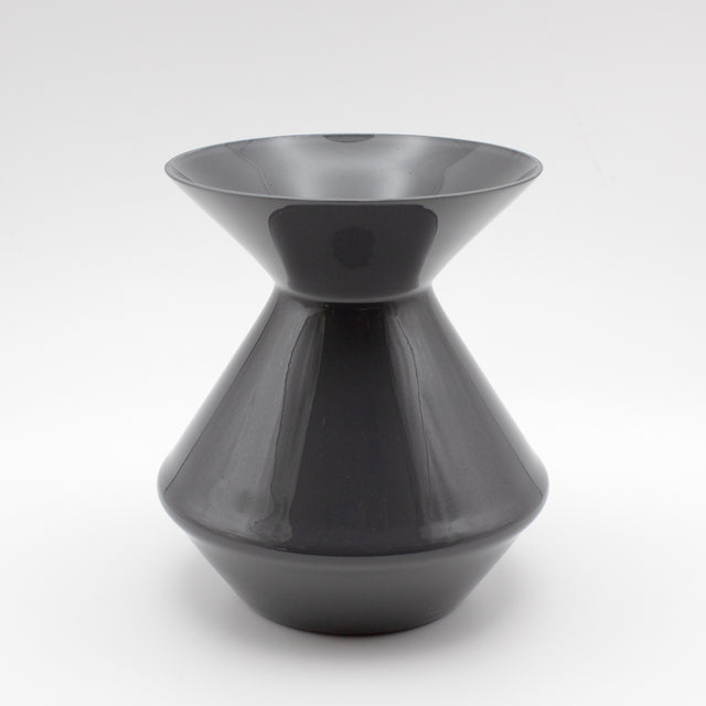 The Zalto Crystal Wine Tasting Spittoon - Dark Grey / Small by Zalto features a sleek, glossy finish with a wide flared top and bottom connected by a narrow center, shown against a plain white background.